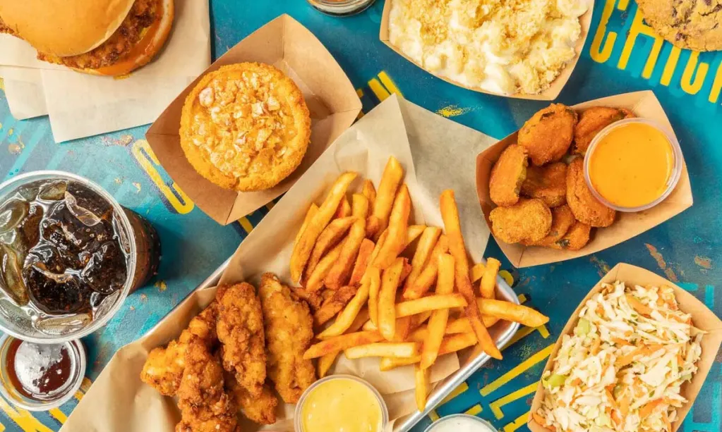 Overhead view of Citizen Chicken menu items, such as chicken tenders, fries, chicken sandwiches