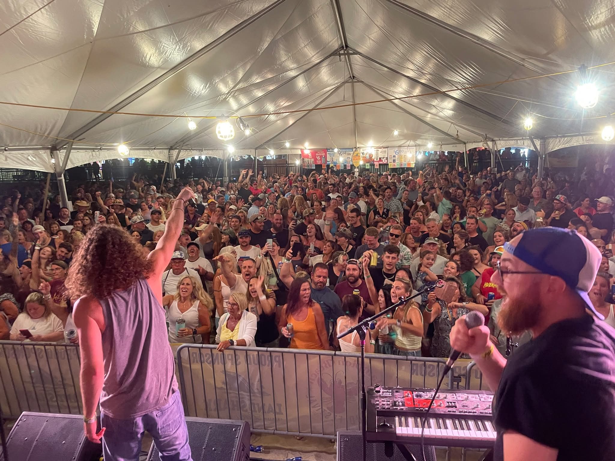 Justin and his band in front of a large crowd, performing